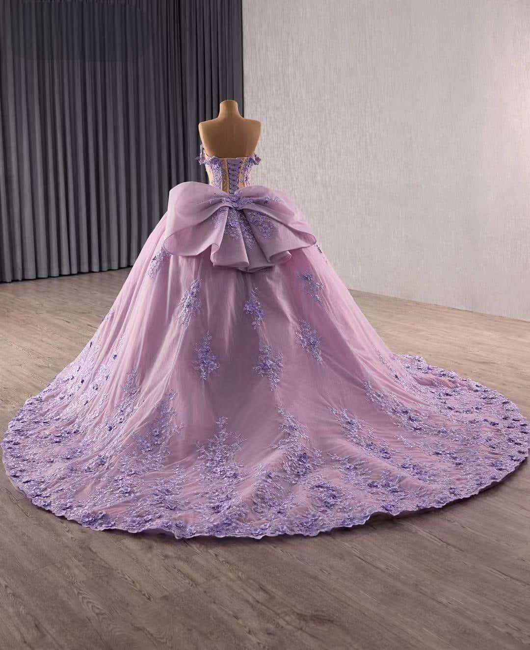 Full back view of lavender princess gown with voluminous tulle skirt and cascading lace train