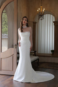 Mermaid wedding dress with sheer long sleeves, beaded illusion neckline and flowing train.
