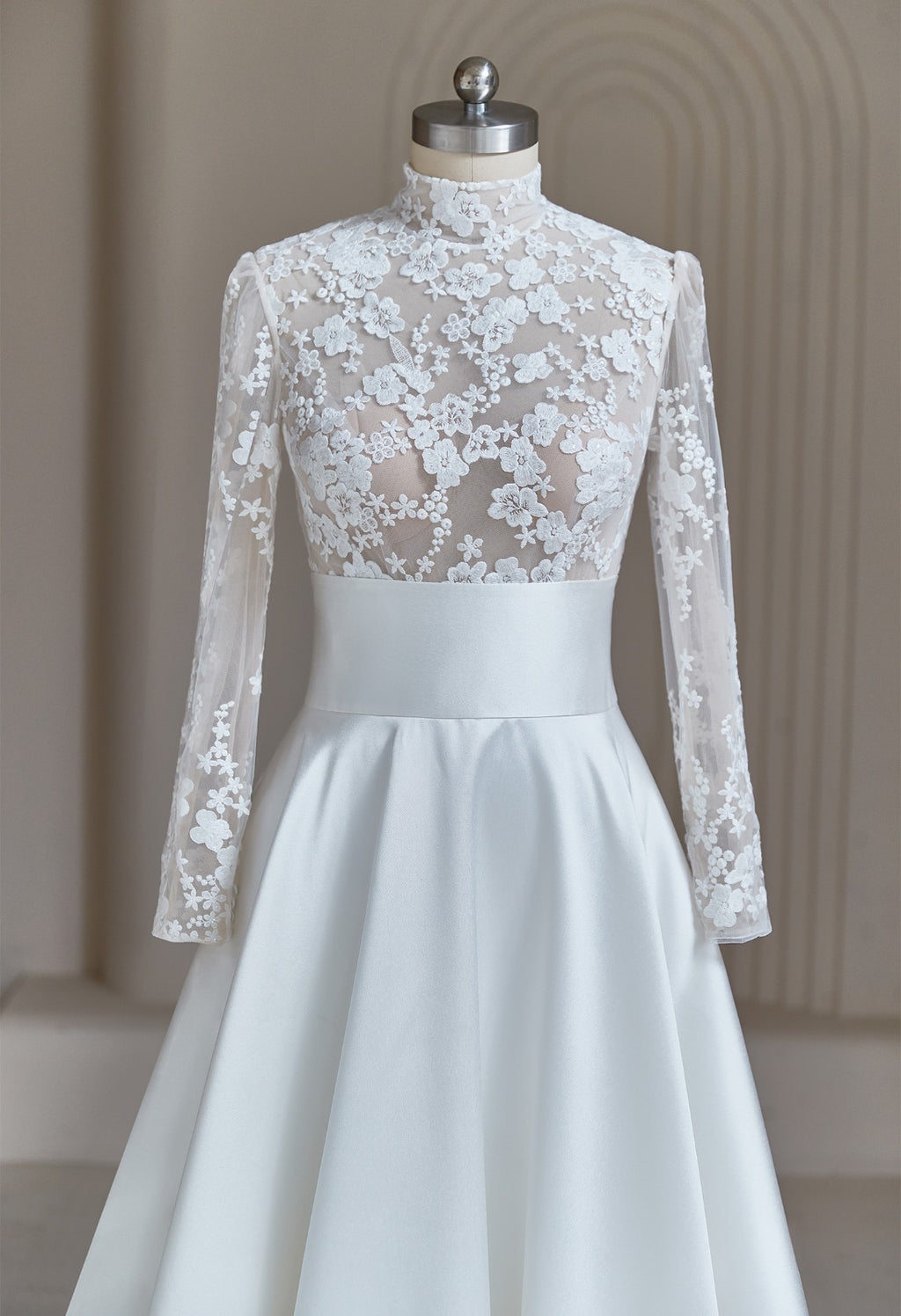Close-up of 3D floral lace applique on high-neck modest wedding dress bodice