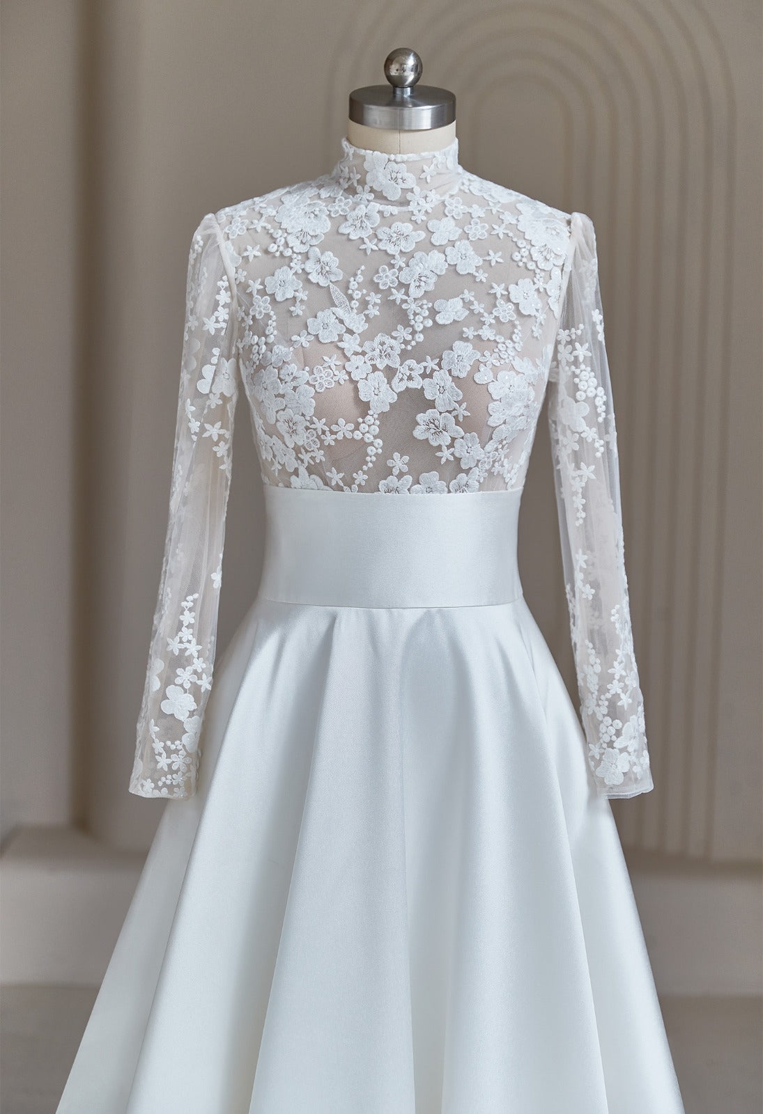 Close-up of 3D floral lace applique on high-neck modest wedding dress bodice