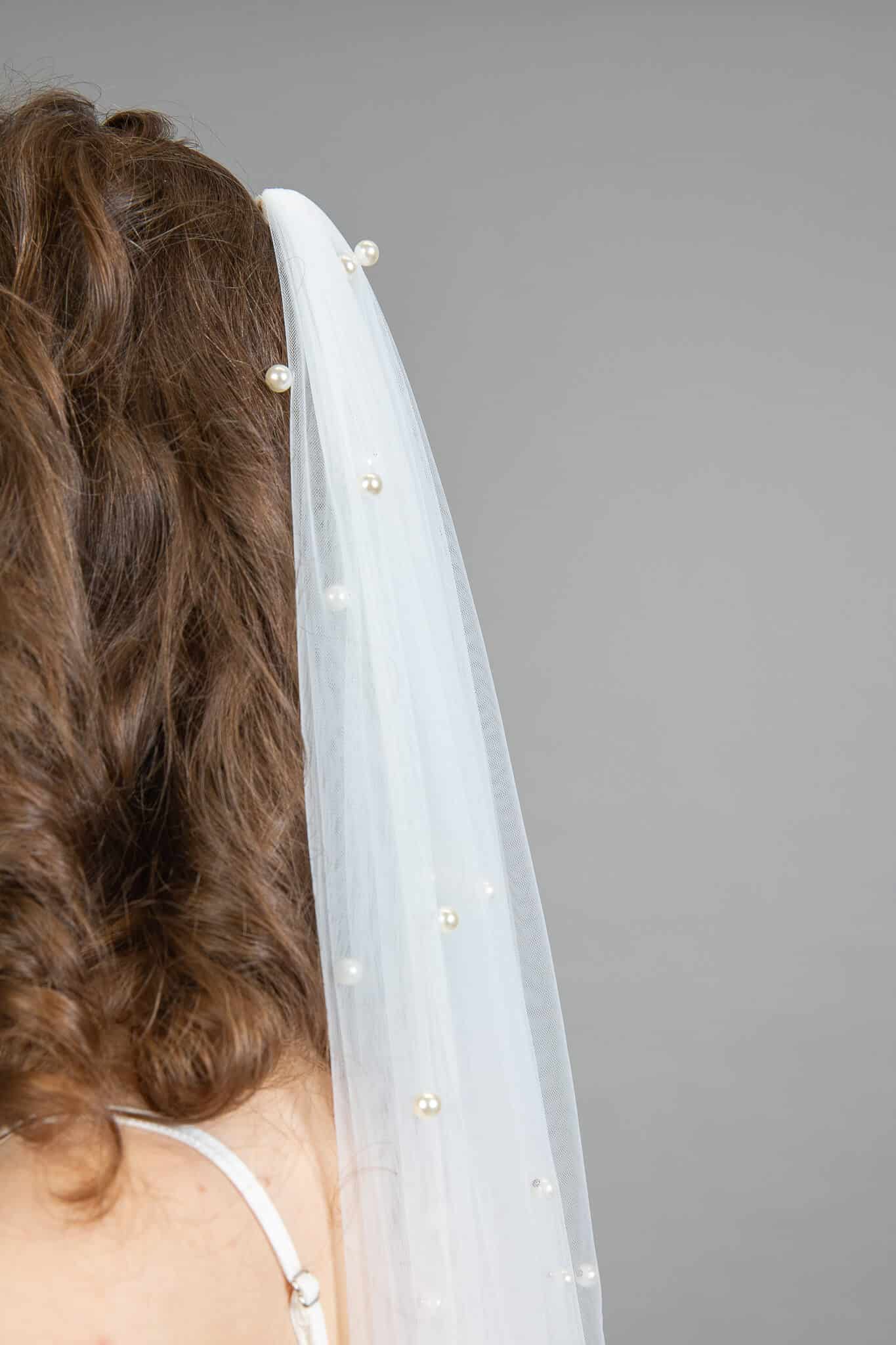 Pearl Veil ivory tulle with scattered pearl beading detail on model's updo - Art Kollocsion Auckland