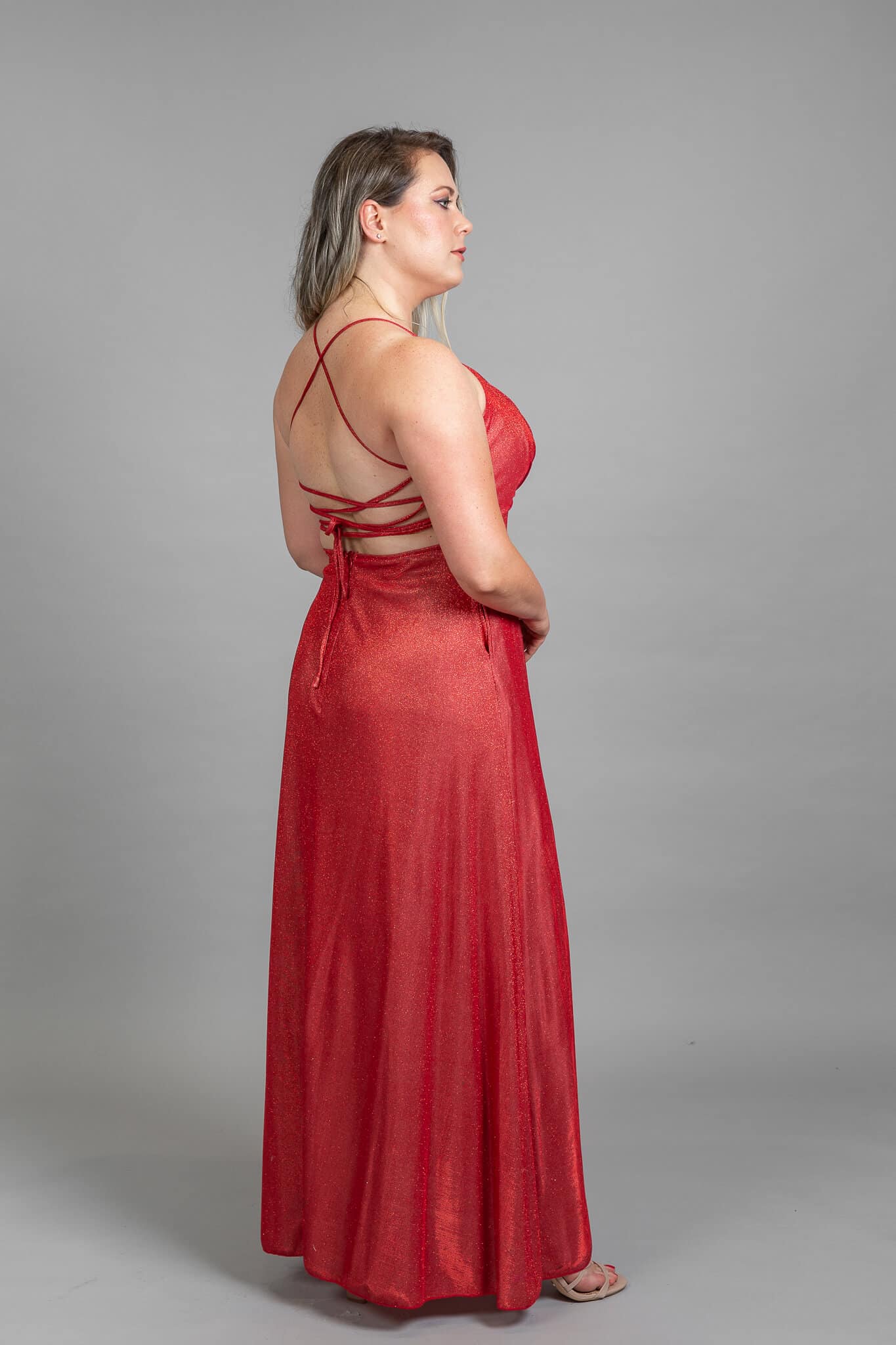 Back view of red dress showing crisscross lace-up strappy design and open back