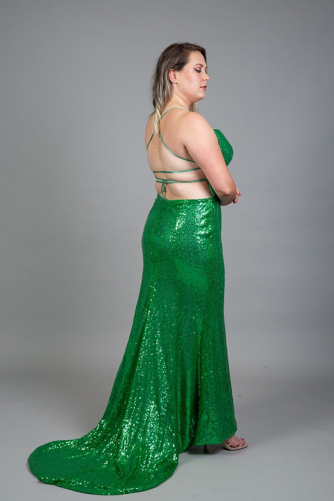 Backless green sequined gown with crisscross straps and flowing train, back view