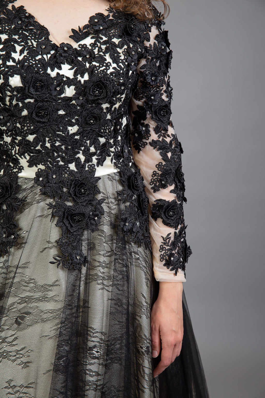 Detail shot of black beaded floral appliqué and sheer tulle skirt on Gothic bridal gown