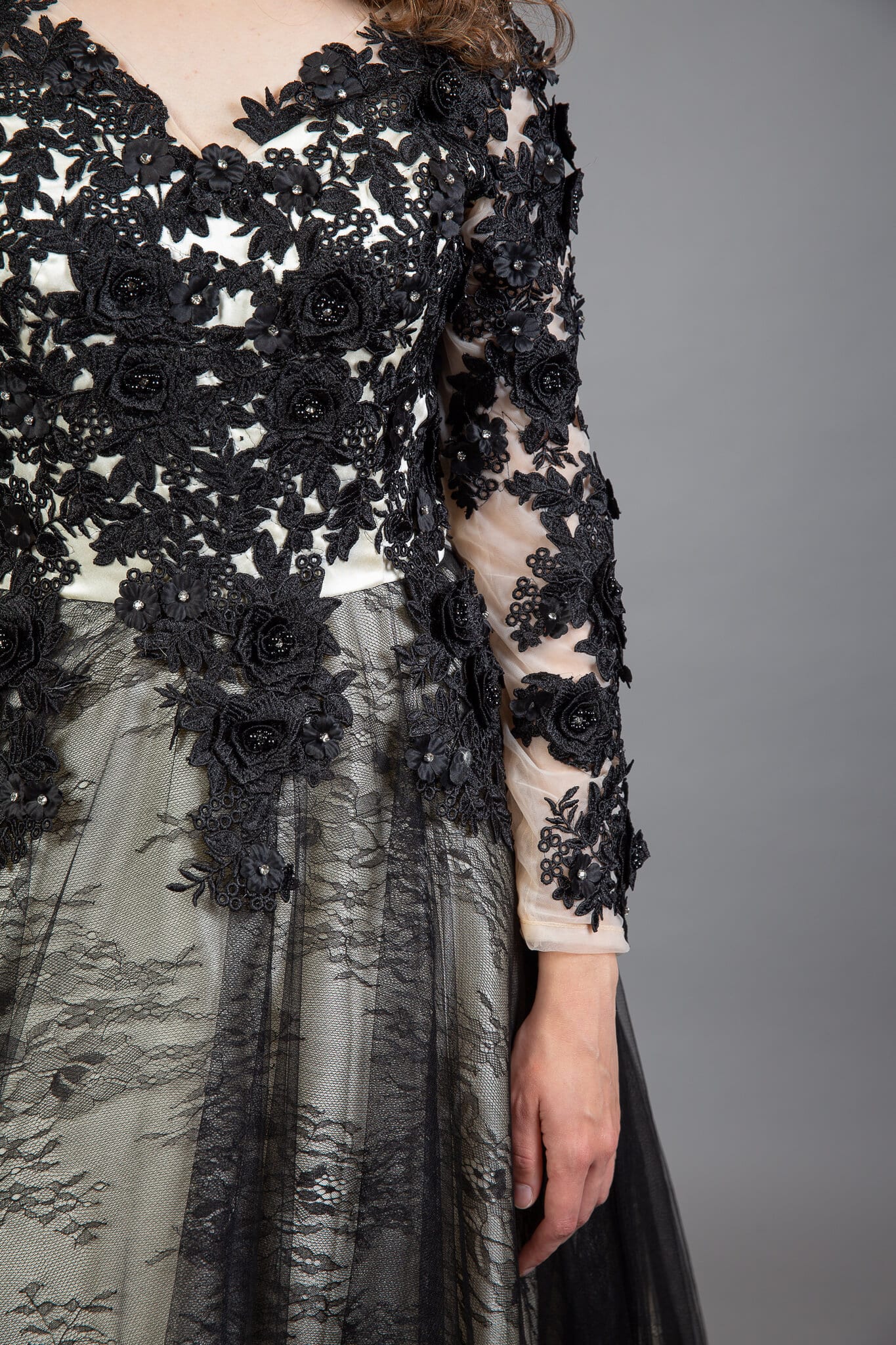 Detail shot of black beaded floral appliqué and sheer tulle skirt on Gothic bridal gown