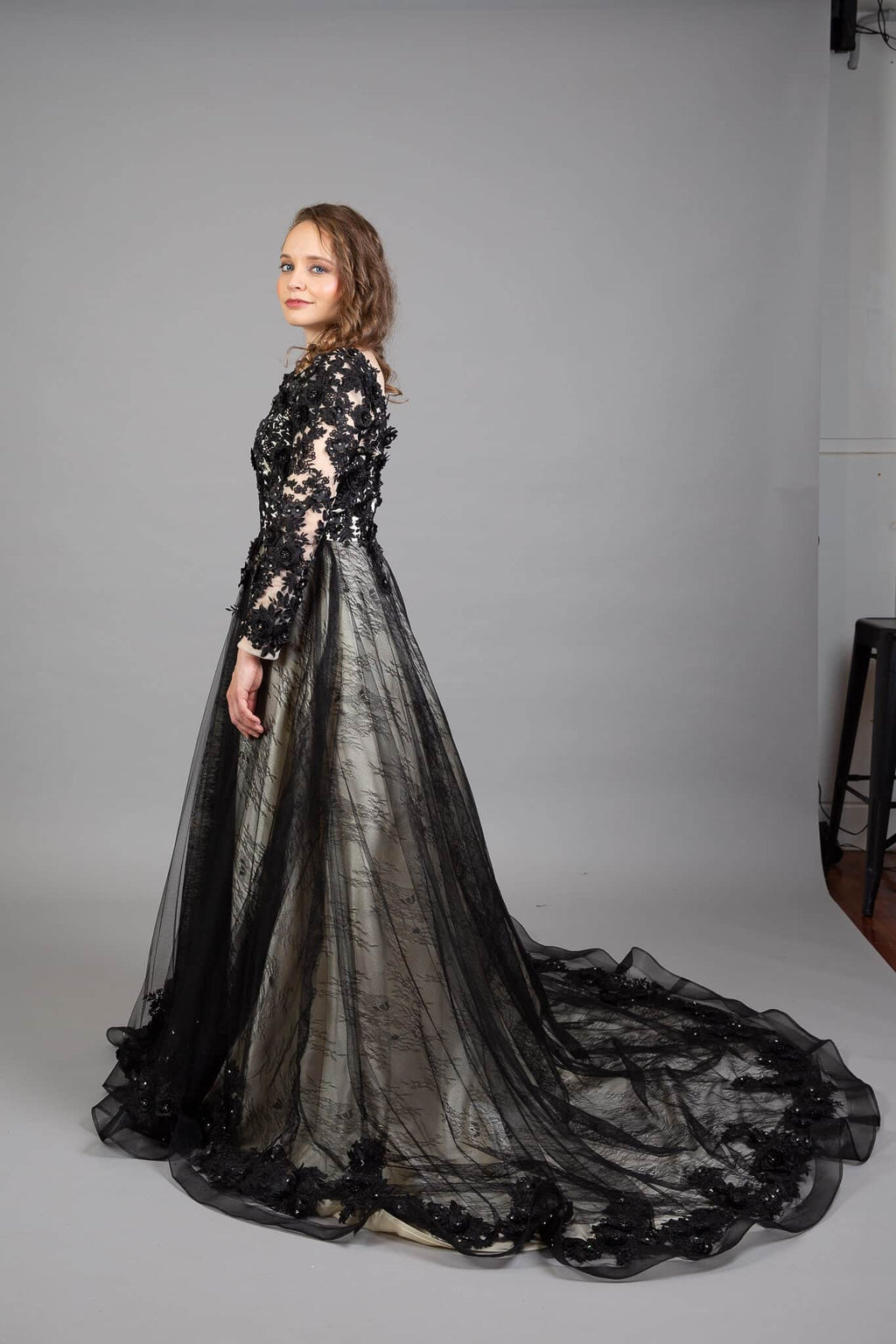 Back view of Gothic wedding dress with intricate beaded bodice, long sleeves, and sweeping train