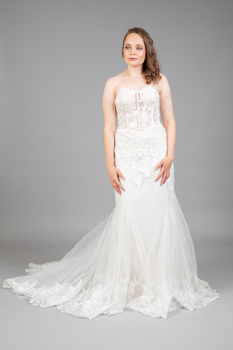 Front view of strapless sweetheart champagne mermaid wedding gown with floral lace and lace-edged tulle train