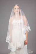 Bride wearing ivory tulle cathedral veil with lace appliqué scalloped edge and blusher, front view – Art Kollocsion Auckland