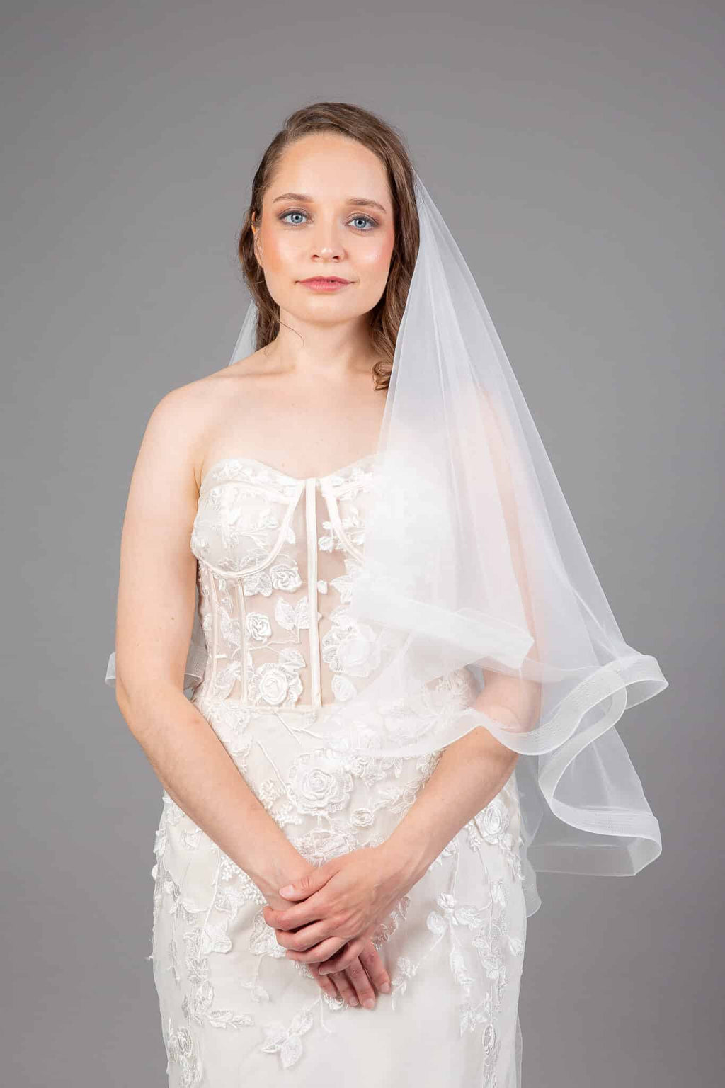 Ivory horsehair edge veil draped to the side, showing the structured tulle edge detail