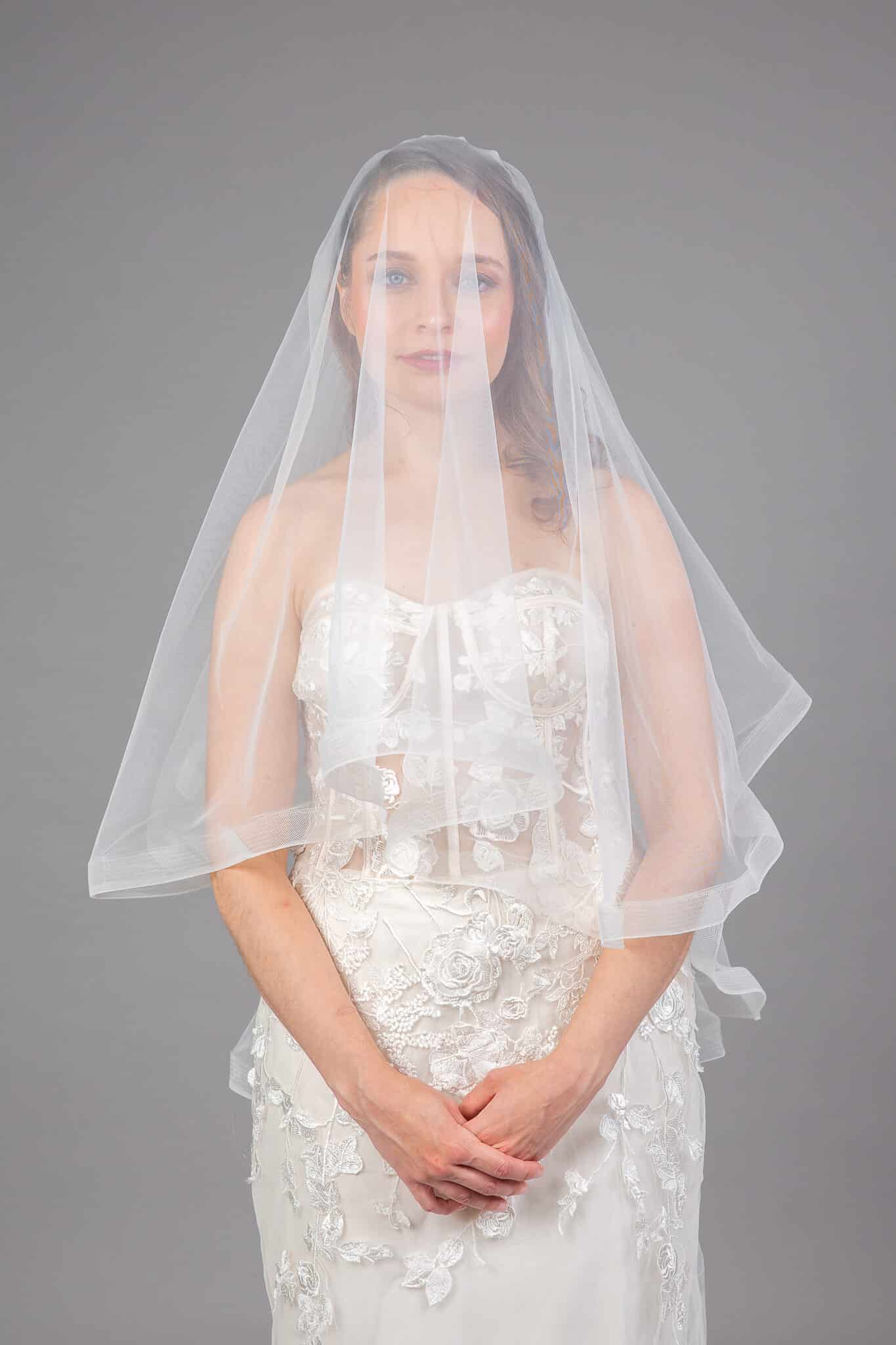 Bride in white horsehair edge veil with cascading tulle, front view – Art Kollocsion Auckland