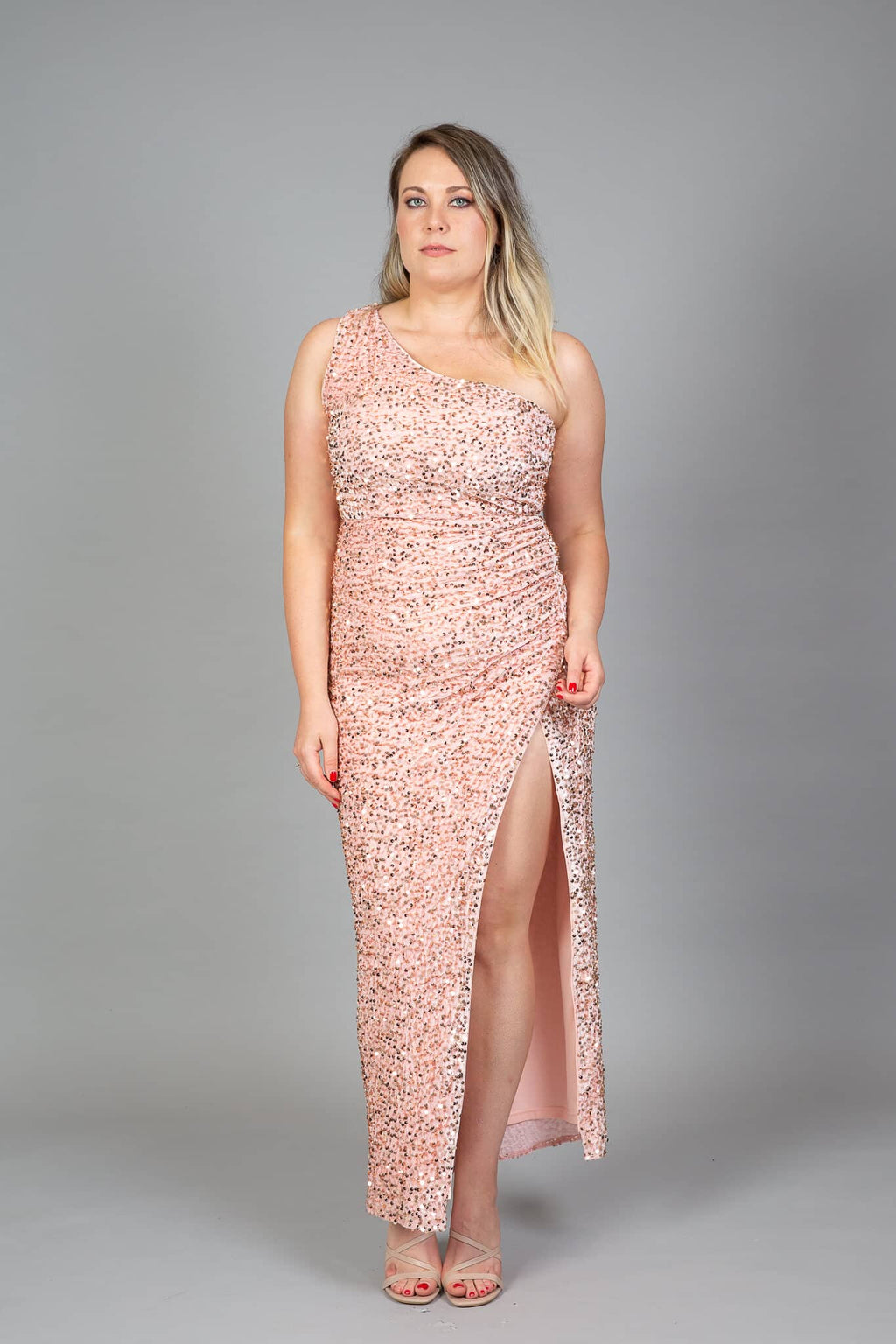 Rose gold sequin one-shoulder gown with high slit and asymmetric neckline