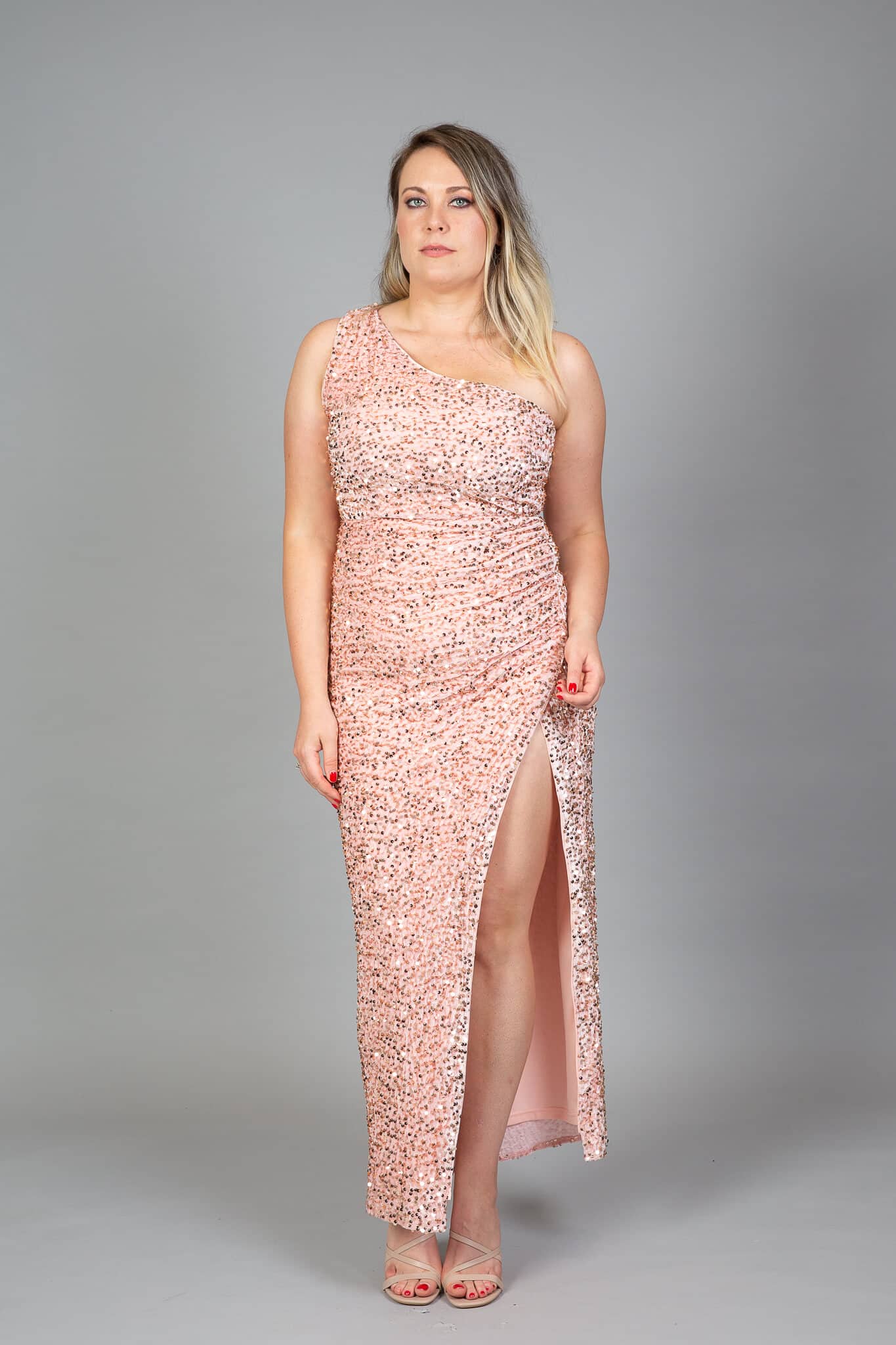 Rose gold sequin one-shoulder gown with high slit and asymmetric neckline