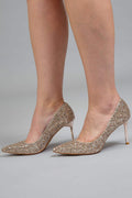 Gold glitter pointed-toe stiletto heels worn on model – Art Kollocsion Auckland