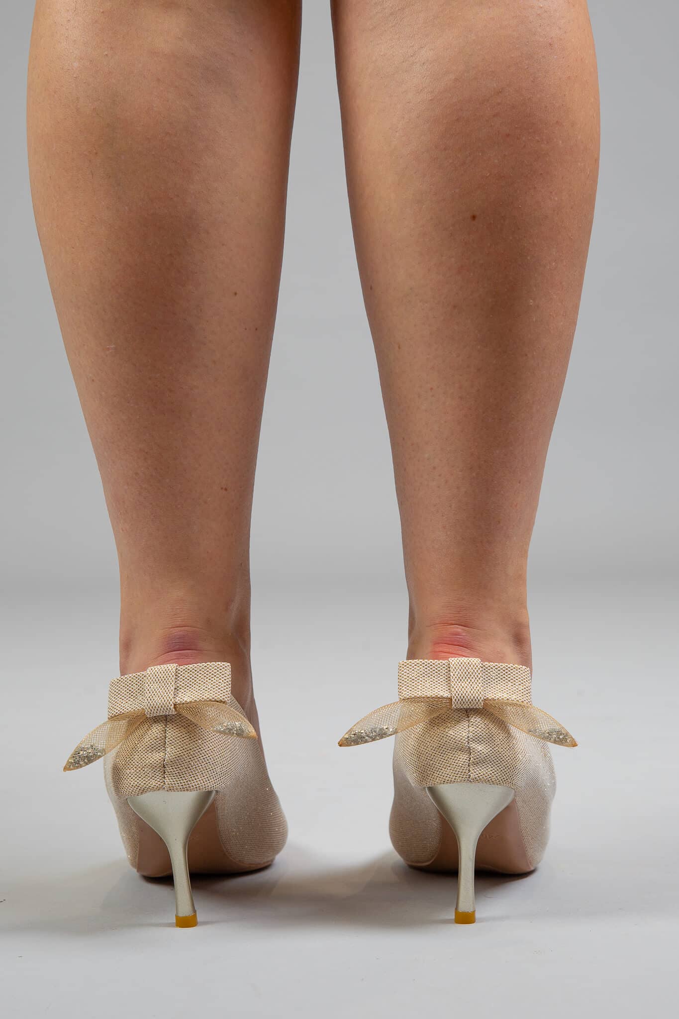 Matte golden heels with textured bow back view, cream stiletto heels with gold accent – AK91
