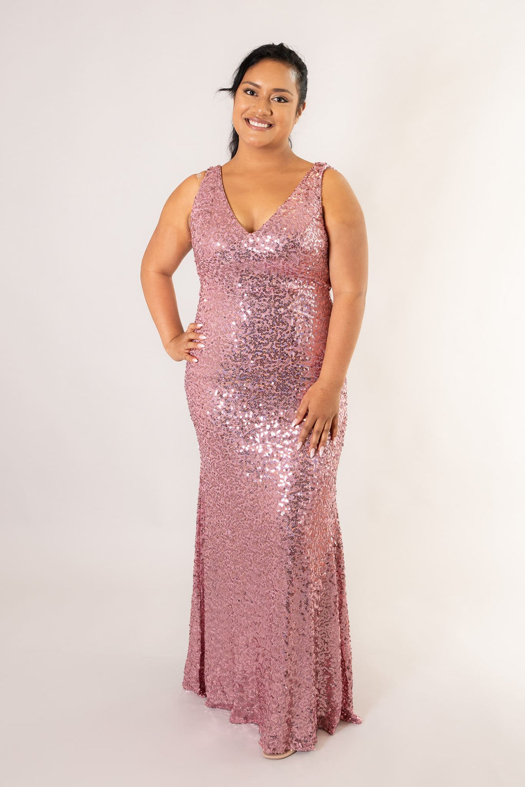 Front view of pink sequin maxi dress with deep V-neckline and fitted bodice on model