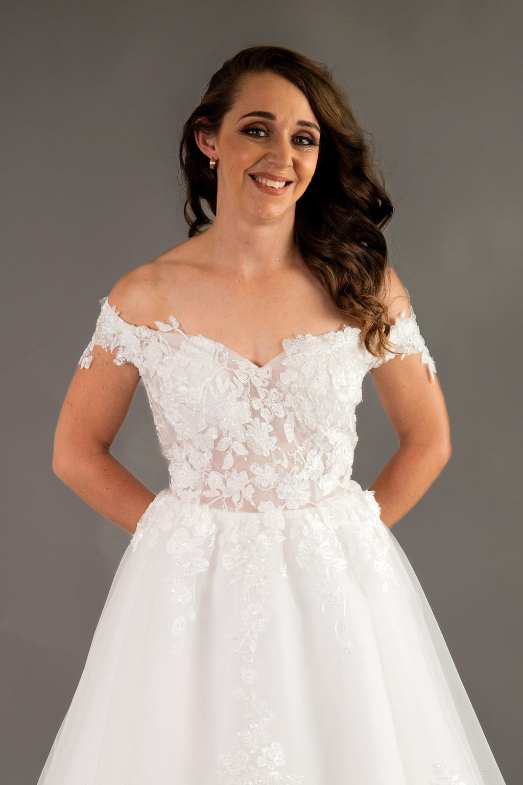 Close-up of intricate beaded lace appliques on off-shoulder neckline detail