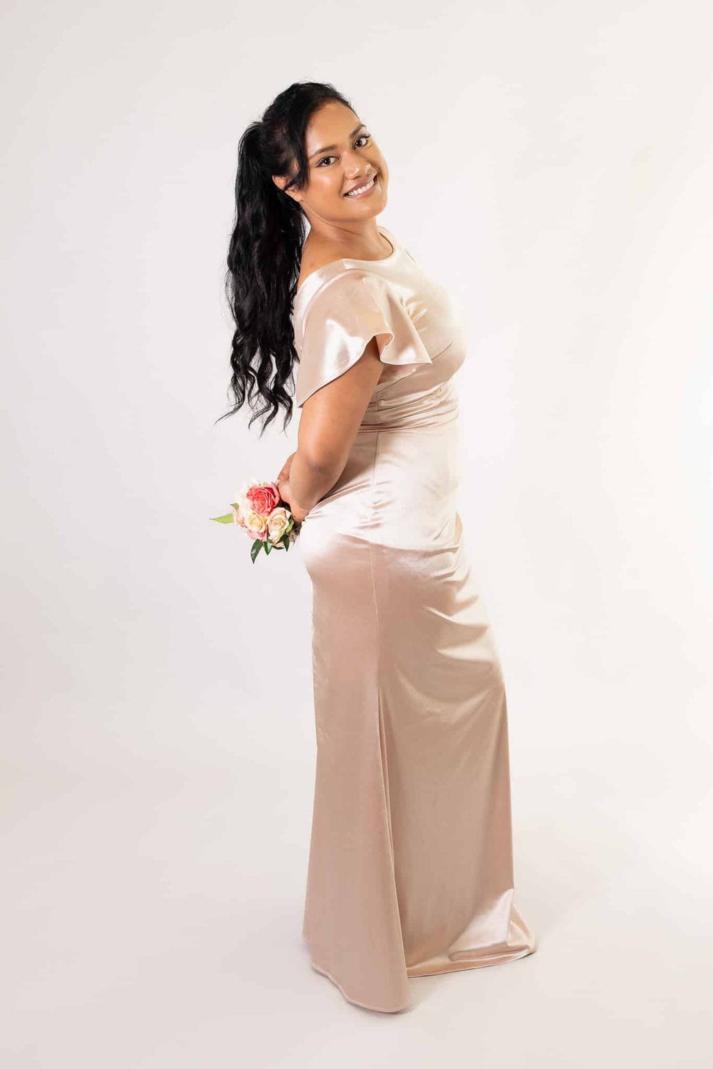 Side angle of silky satin bridesmaids dress showing ruched bodice detail and fit
