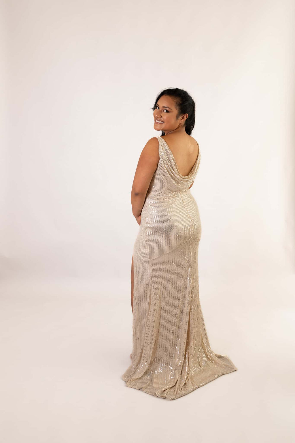 Back view of champagne sequined mermaid gown with draped cowl neckline