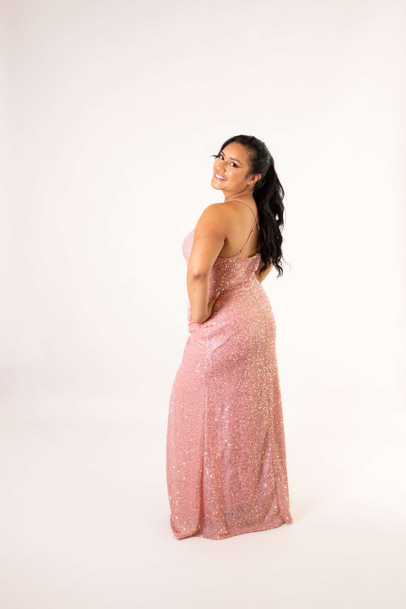 Back view of rose pink sequin gown with open back and crisscross straps