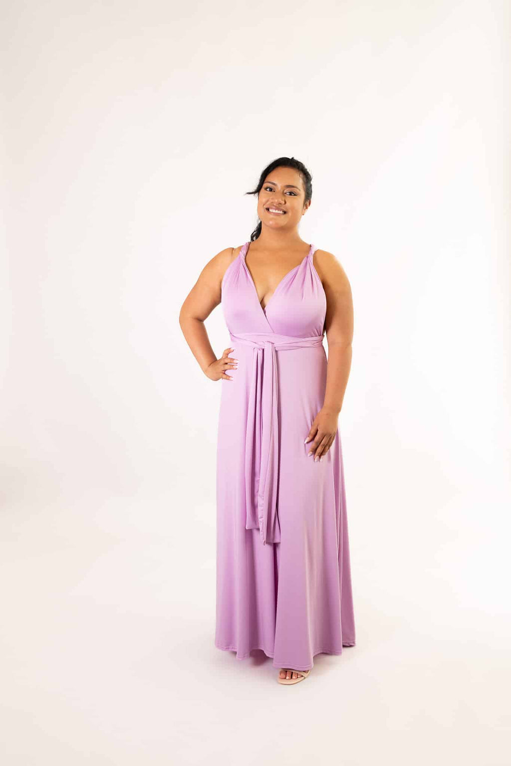 Lilac infinity dress tied in a V-neck style with front waist sash, full-length on smiling model