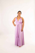 Lilac infinity dress tied in a V-neck style with front waist sash, full-length on smiling model