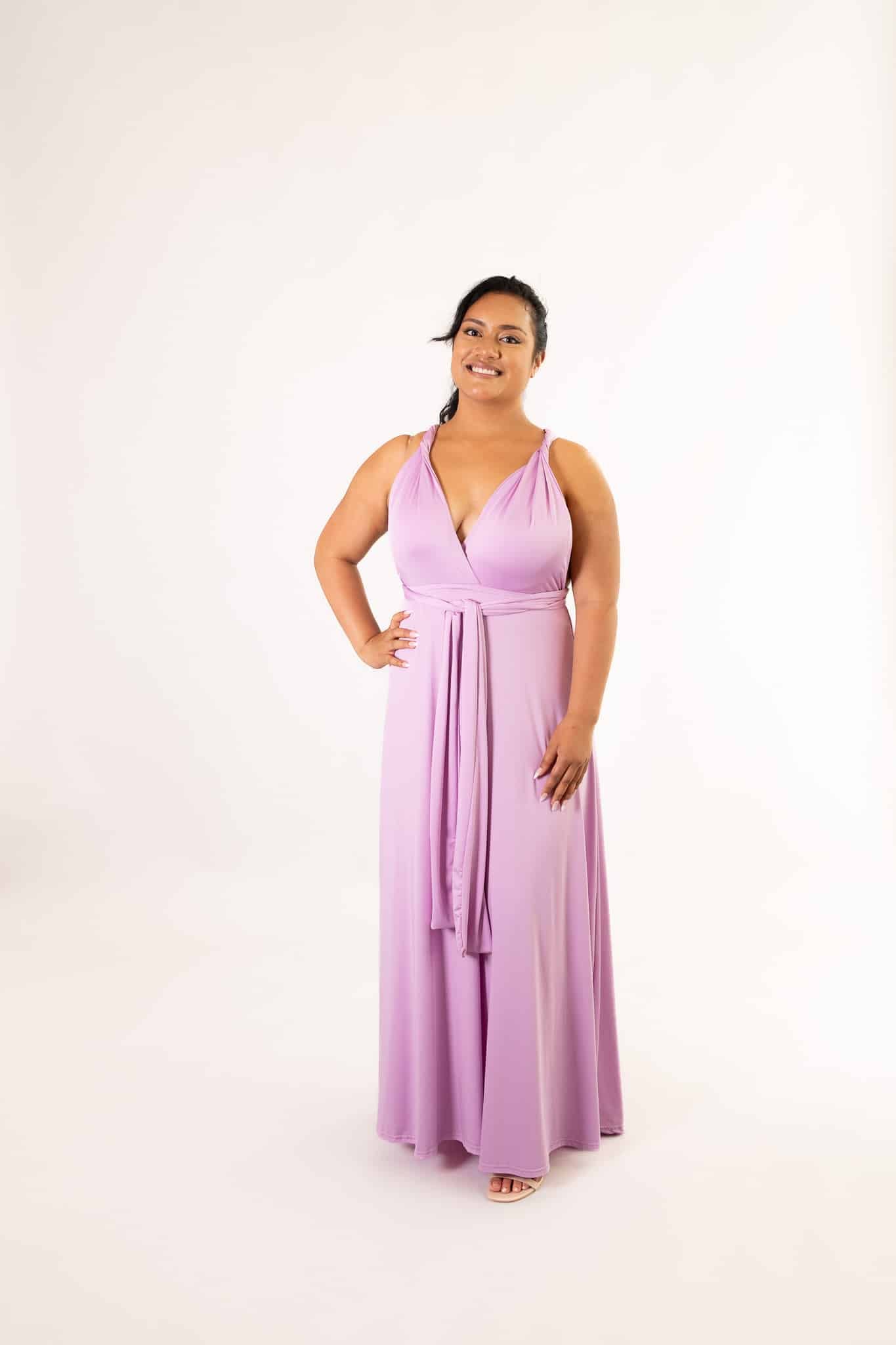 Lilac infinity dress tied in a V-neck style with front waist sash, full-length on smiling model