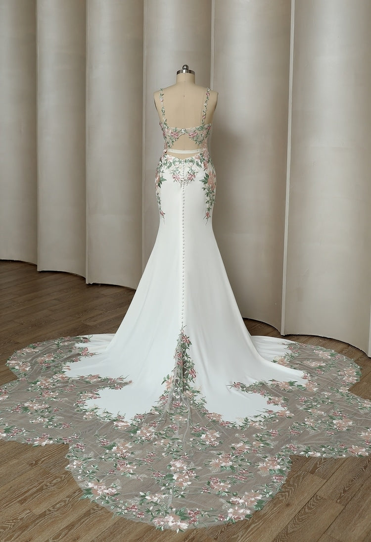 Back view of slim mermaid wedding dress with embroidered petal train trailing floor