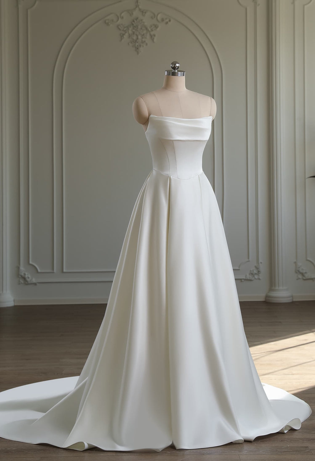 Full-length ivory satin A-line gown with off-shoulder cowl neckline and flowing satin skirt