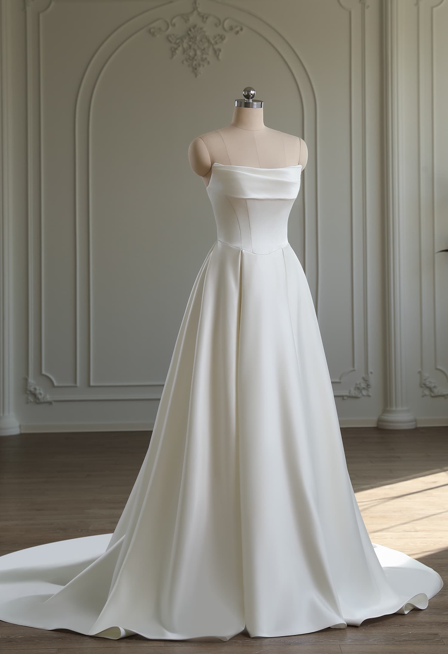 Full-length ivory satin A-line gown with off-shoulder cowl neckline and flowing satin skirt