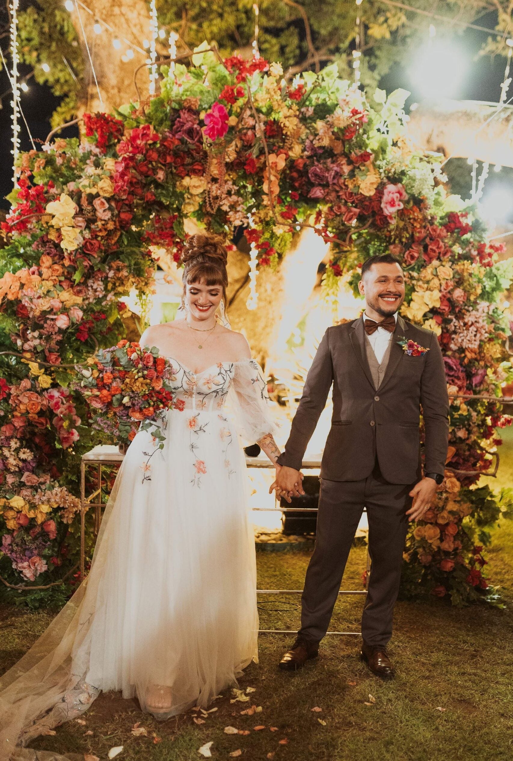 Bride in floral patterned wedding dress with flowing tulle skirt and sweetheart neckline at ceremony – Art Kollocsion Auckland