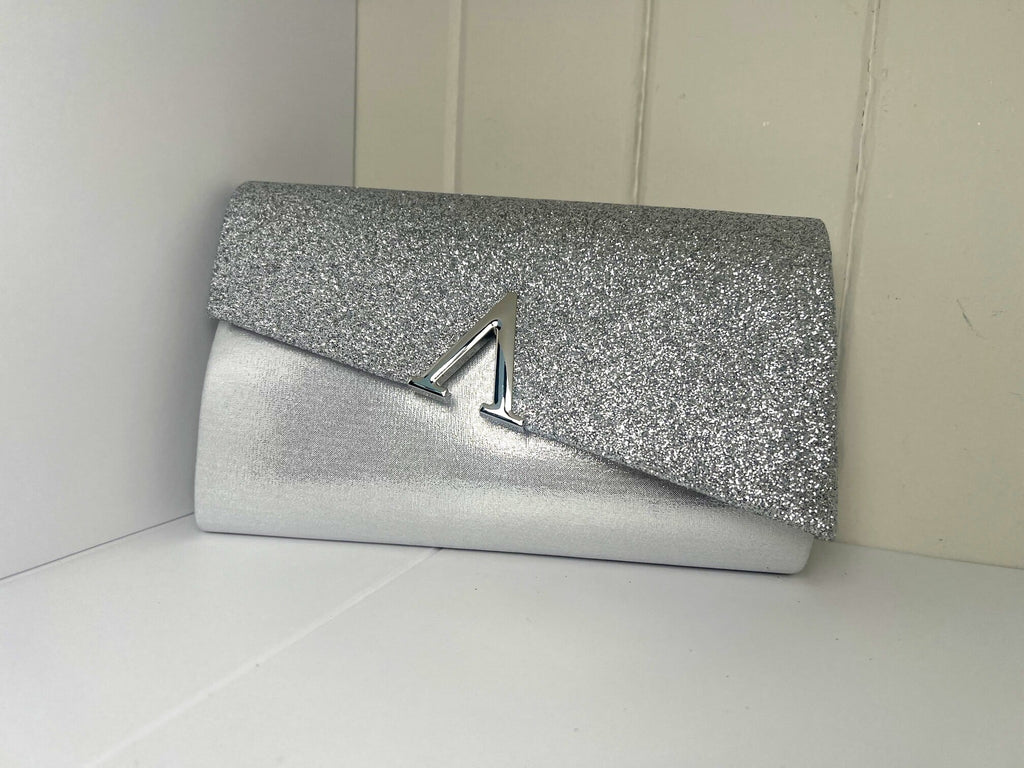 Silver glitter clutch with metallic trim detail and gold chain strap