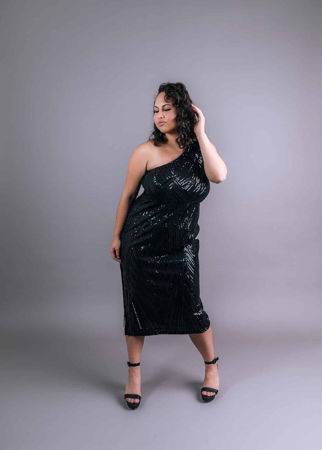 Black asymmetrical one-shoulder sequined dress with V-shaped geometric pattern, front view
