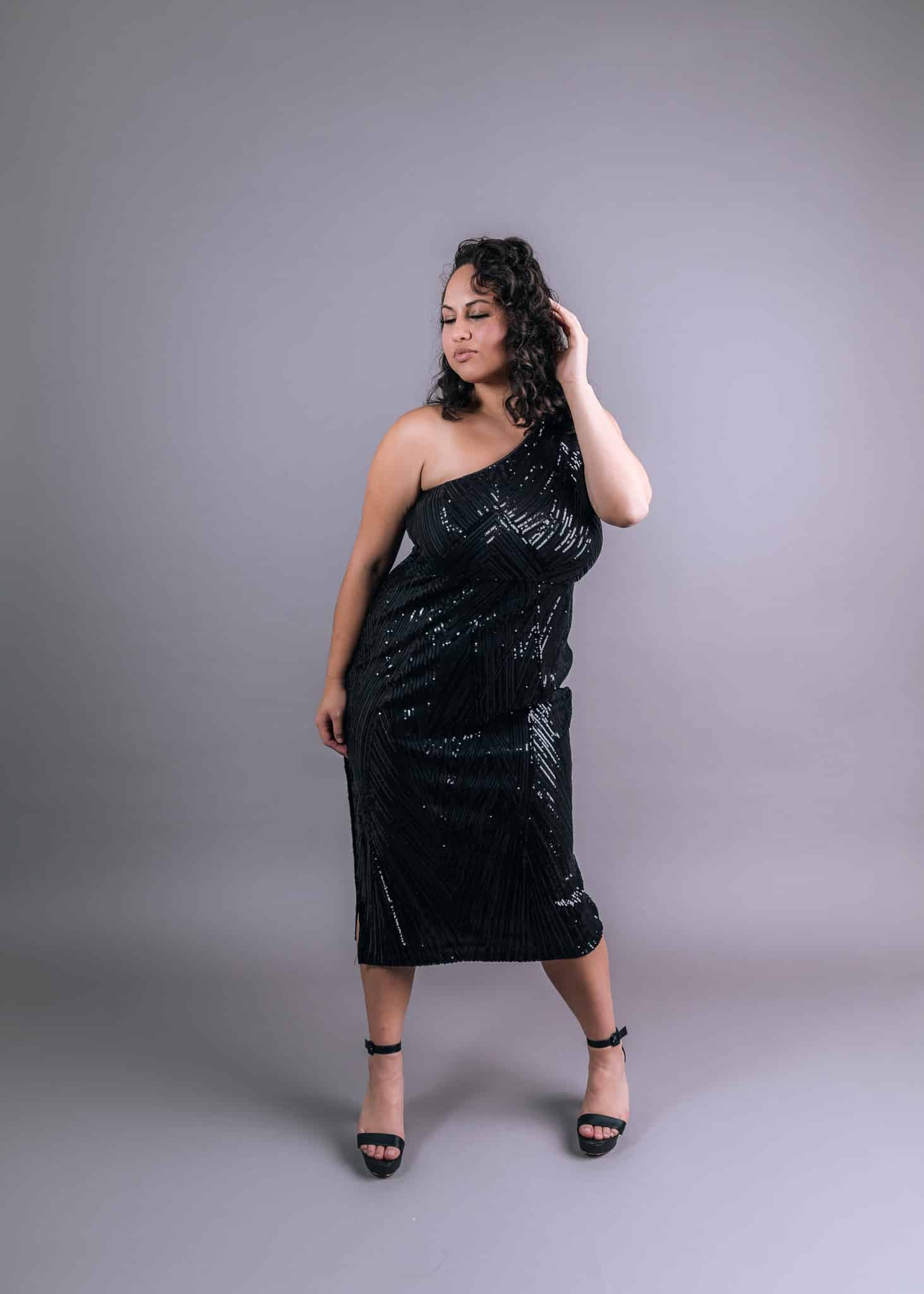 Black asymmetrical one-shoulder sequined dress with V-shaped geometric pattern, front view