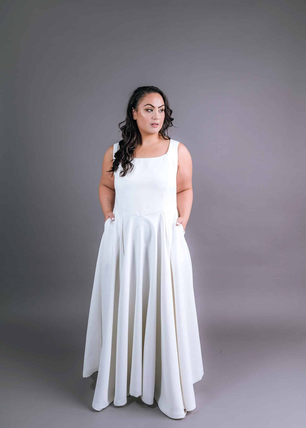 Plus-size wedding dress with graceful pleated skirt and functional side pockets