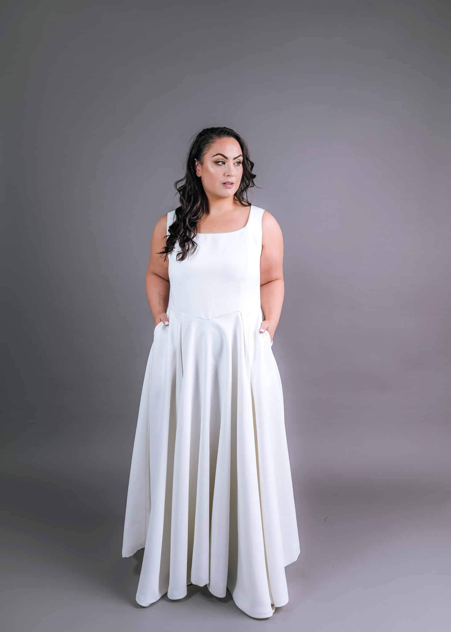 Plus-size wedding dress with graceful pleated skirt and functional side pockets