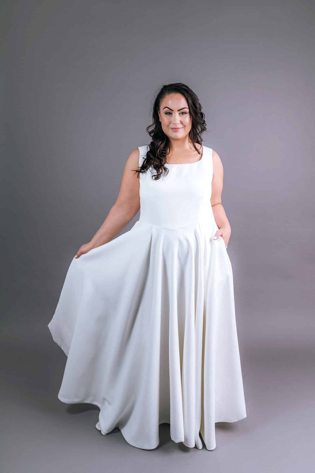 White sleeveless wedding gown with scoop neckline and A-line skirt – Art Kollocsion Auckland