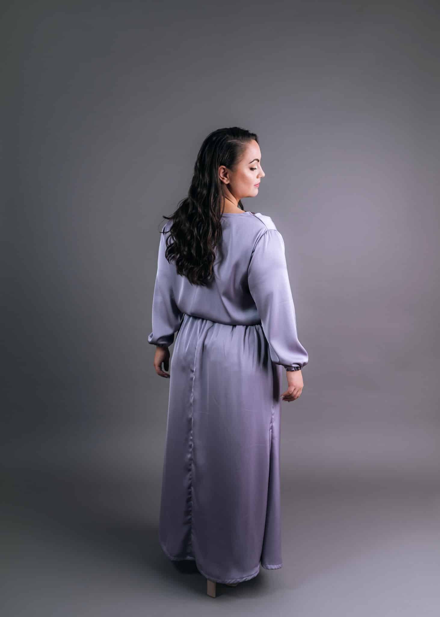 Back view of modest lavender silk bridesmaid outfit with elegant button-down detail and soft draping