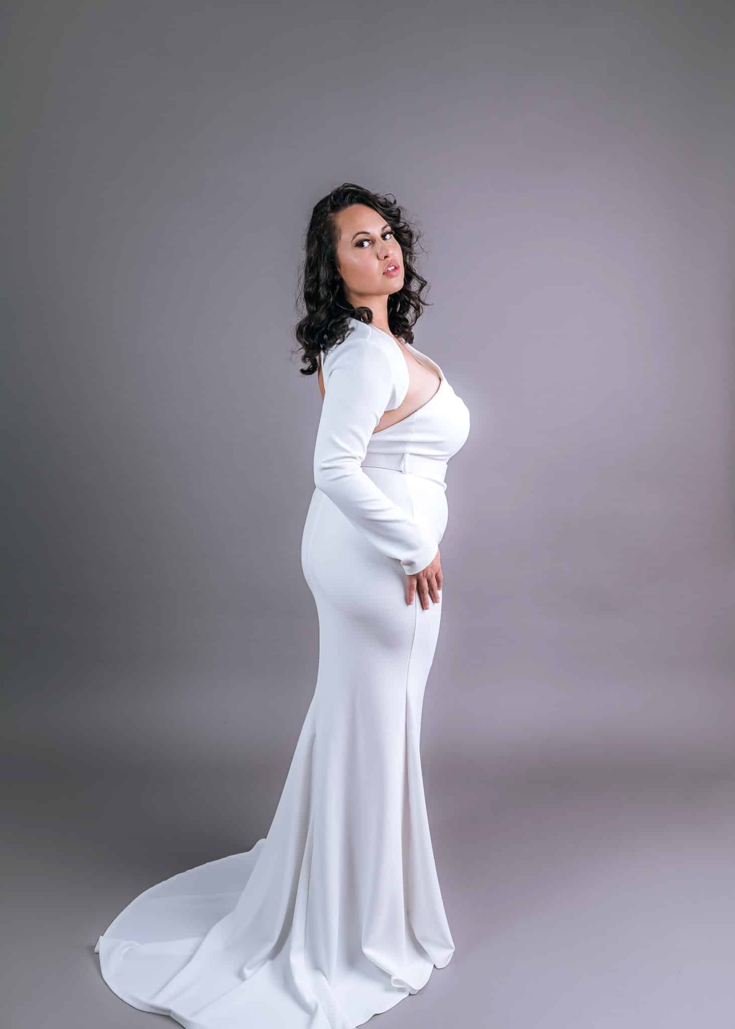 White long-sleeve mermaid wedding dress with side cutout and flowing train – Art Kollocsion Auckland