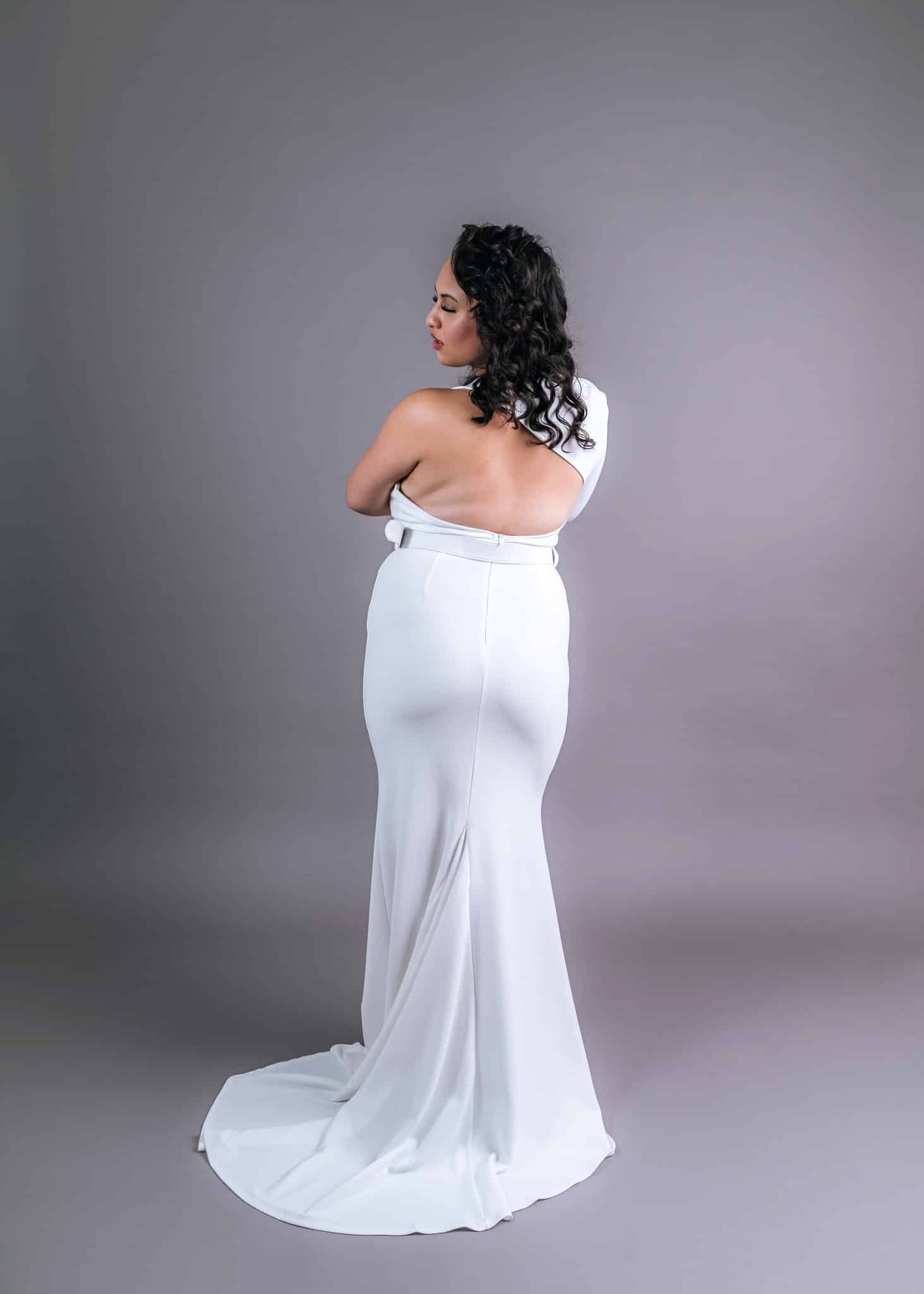 Back view of white mermaid train wedding dress with open back and sweeping train – Art Kollocsion Auckland