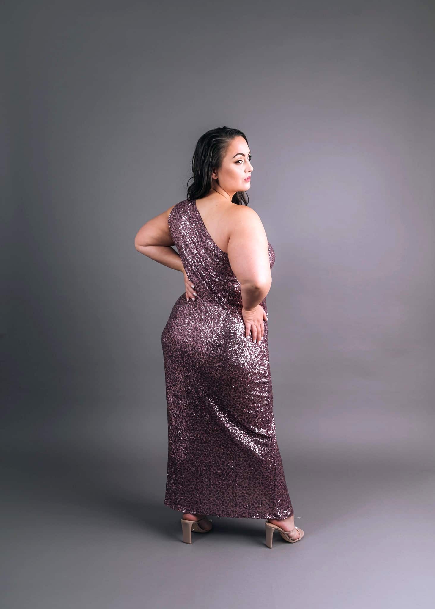 Model wearing dusty mauve sequin gown with one-shoulder neckline, back view – Art Kollocsion Auckland