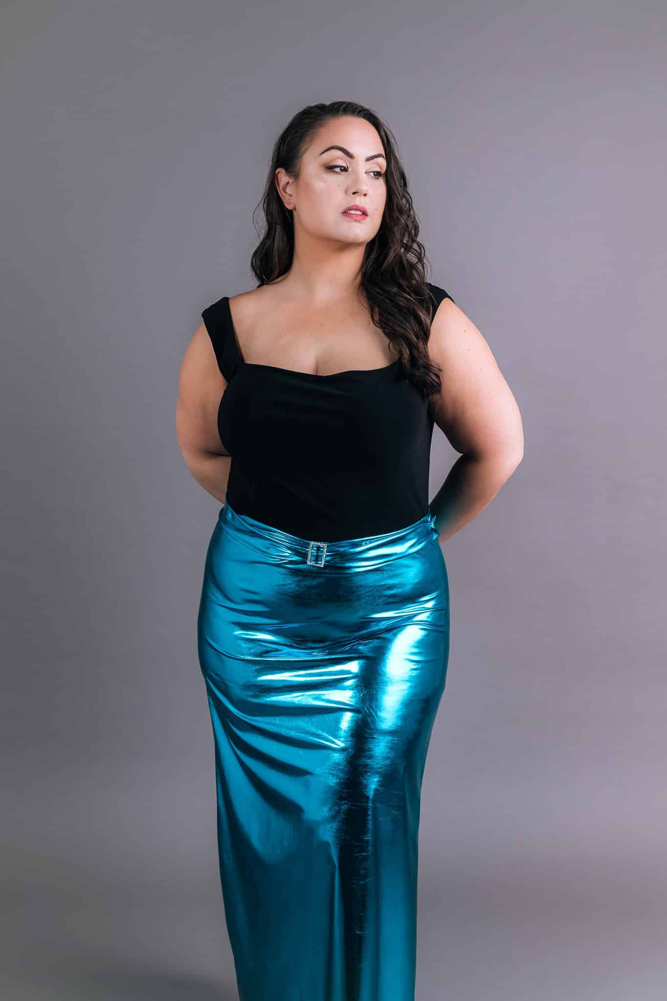 Front view of electric blue metallic skirt with ruched detail and square neckline black top