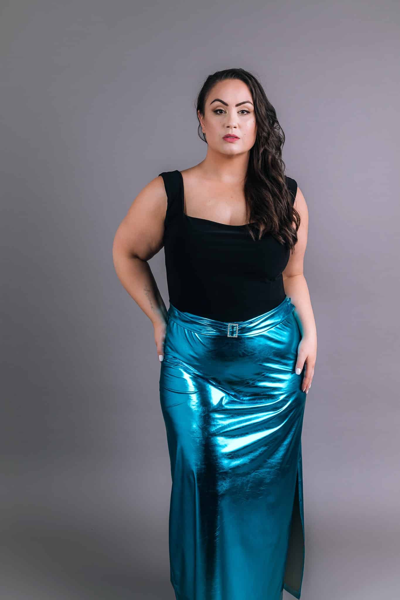 Model wearing electric blue metallic dress with draped bodice detail and shimmer finish