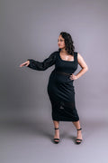 Attachable sleeve in sheer black organza worn on one arm of a black midi dress, front view – Art Kollocsion Auckland