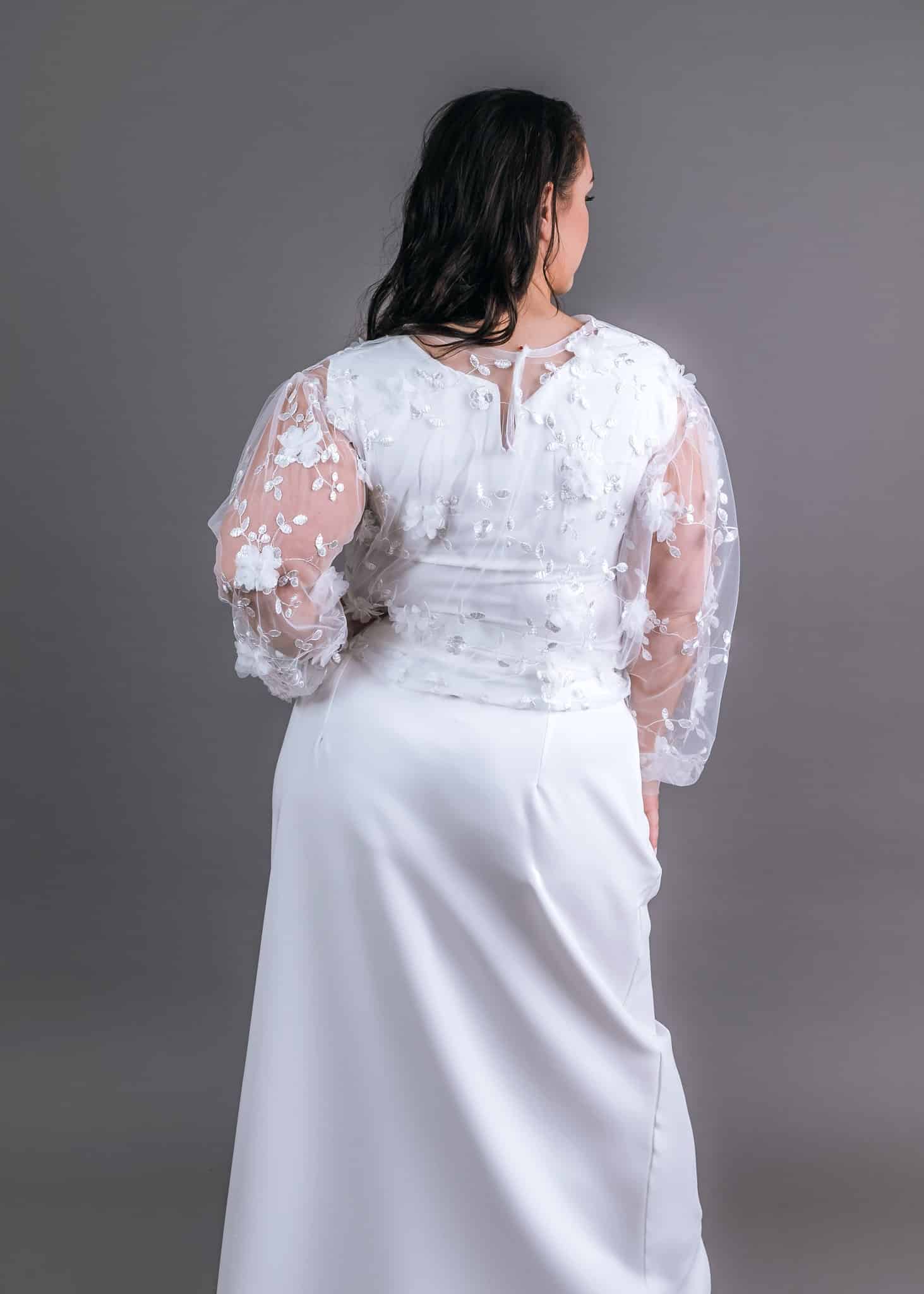 Graceful Ivory reception dress back view with sheer lace sleeves and floral appliqués – Art Kollocsion Auckland