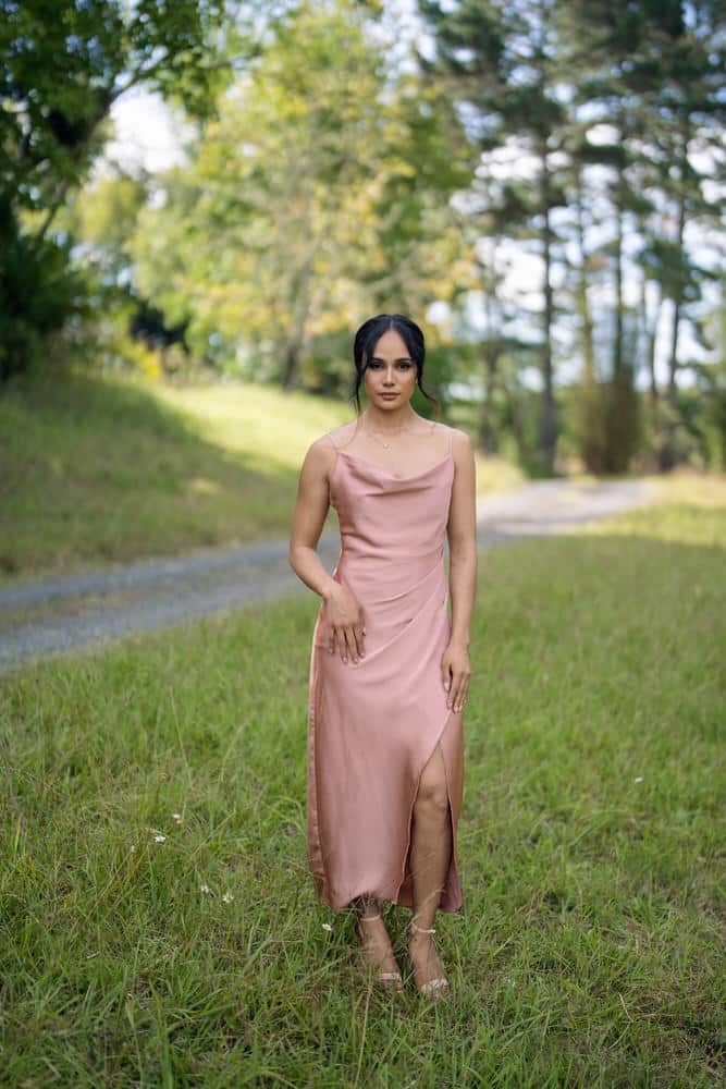 Dusty pink cowl neck satin dress with front leg split and ruched waist, full-length front view on model