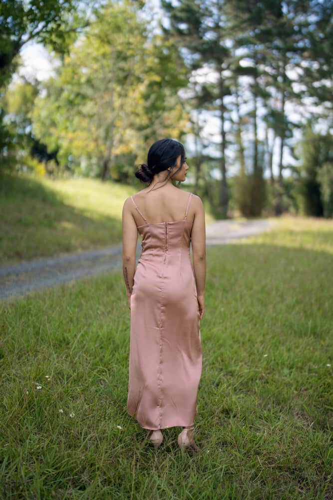 Back view of dusty rose satin bridesmaids dress showing low back, thin straps and centre back seam