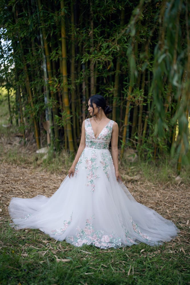 Three-quarter angle of ballgown silhouette with cascading floral embroidery detail