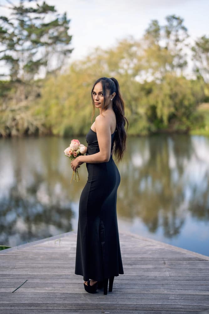 Black one shoulder bridesmaids dress, fitted maxi with leg slit, side view on model – Art Kollocsion Auckland