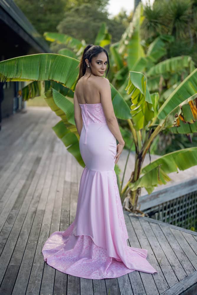 Back view of lavender mermaid gown showing strapless design with textured bodice and flowing fishtail train