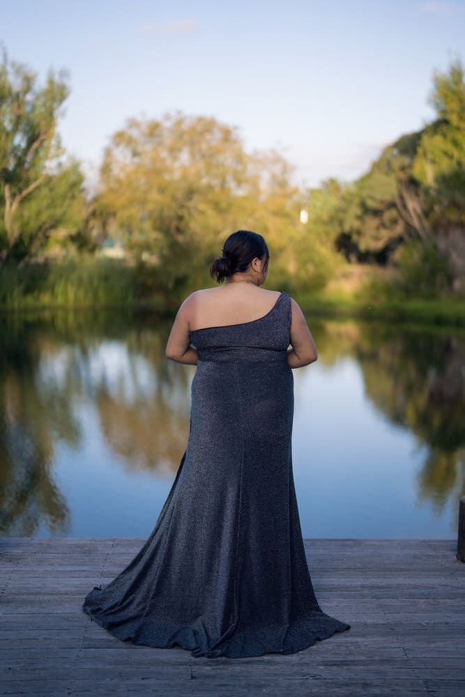 Back view of sparkle charcoal gown with elegant drape and trailing train